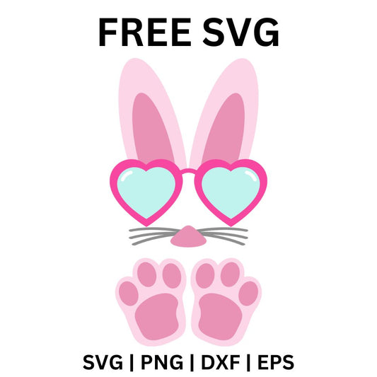 Pink bunny ears above pink heart-shaped sunglasses with mint lenses, whiskers and two pink bunny paws below, free Easter bunny sunglasses SVG cut file preview.