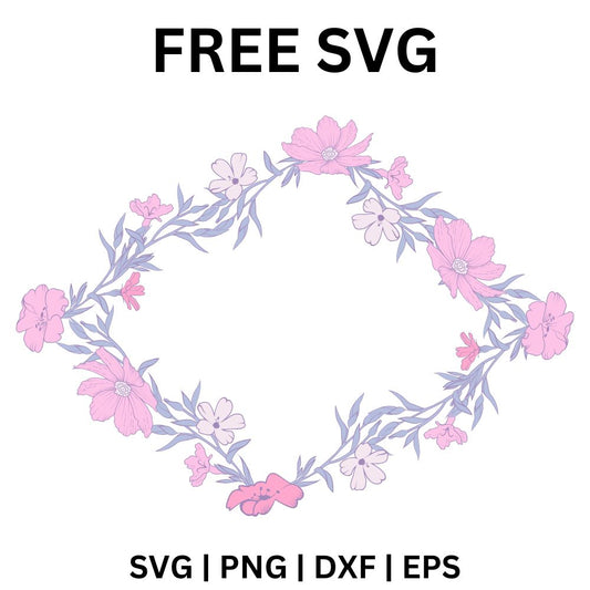 Oval wreath of soft pink watercolor blossoms and lilac leaves with an open center, free blossom wreath frame SVG cut file preview.